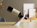 3D printed hand-shaped wine bottle holder on a kitchen counter