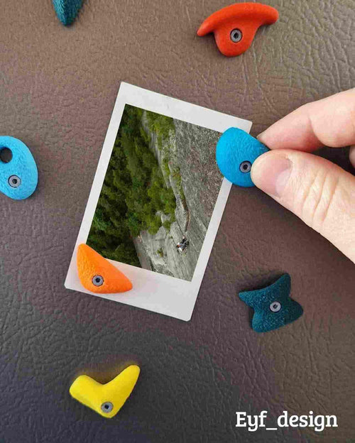 3D printed climbing hold magnets on a refrigerator door