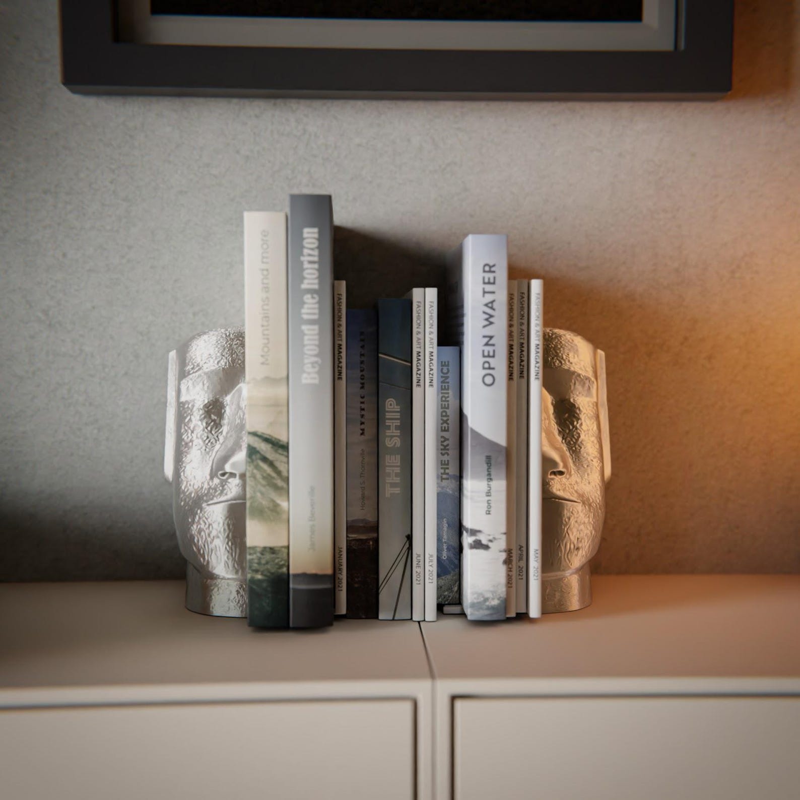 Moai bookends — pair holding books