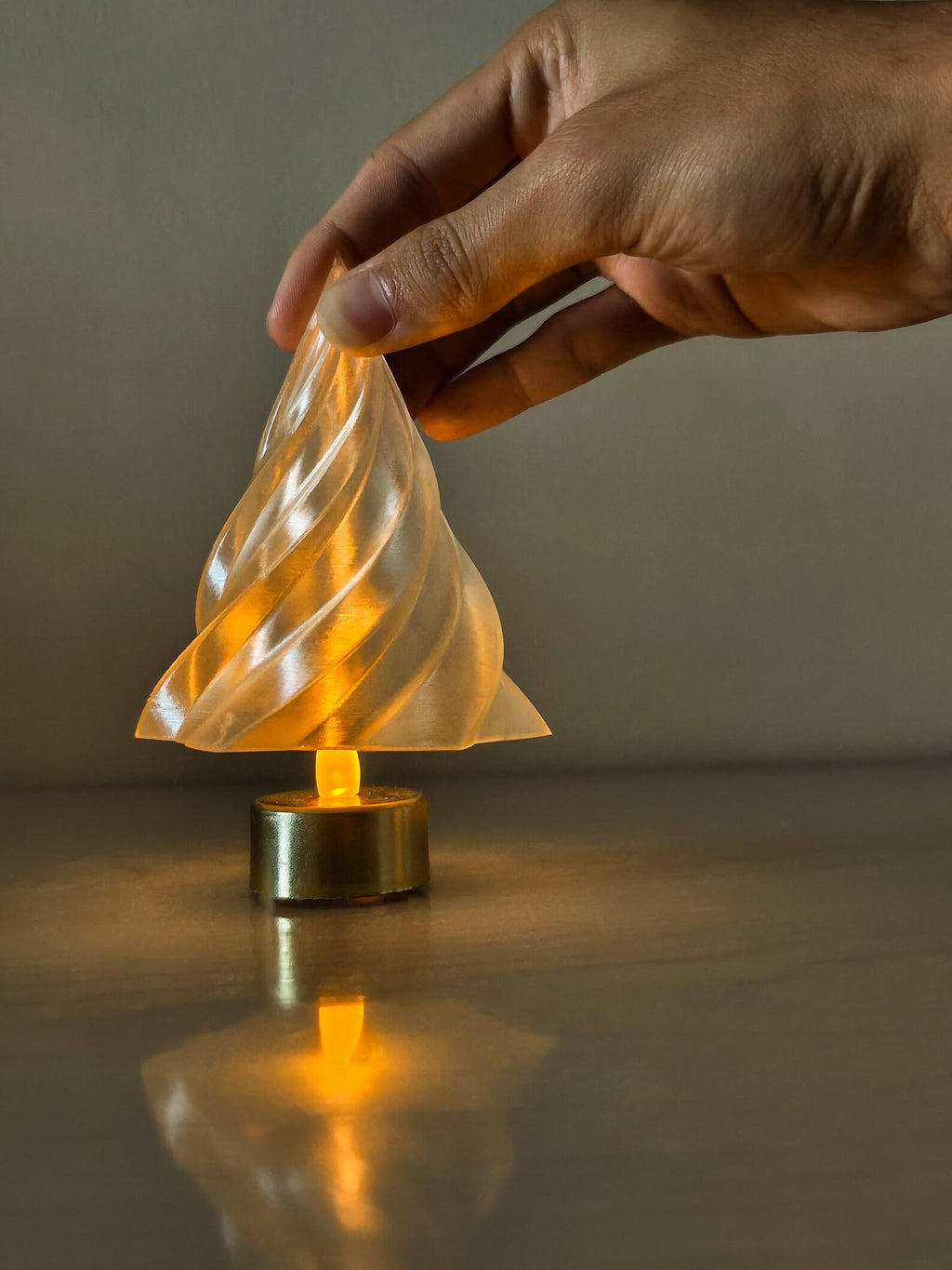Kiki Christmas tree lamp — glowing over tealight