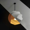 Sofia 3D printed ripple pendant lamp shade glowing above a table