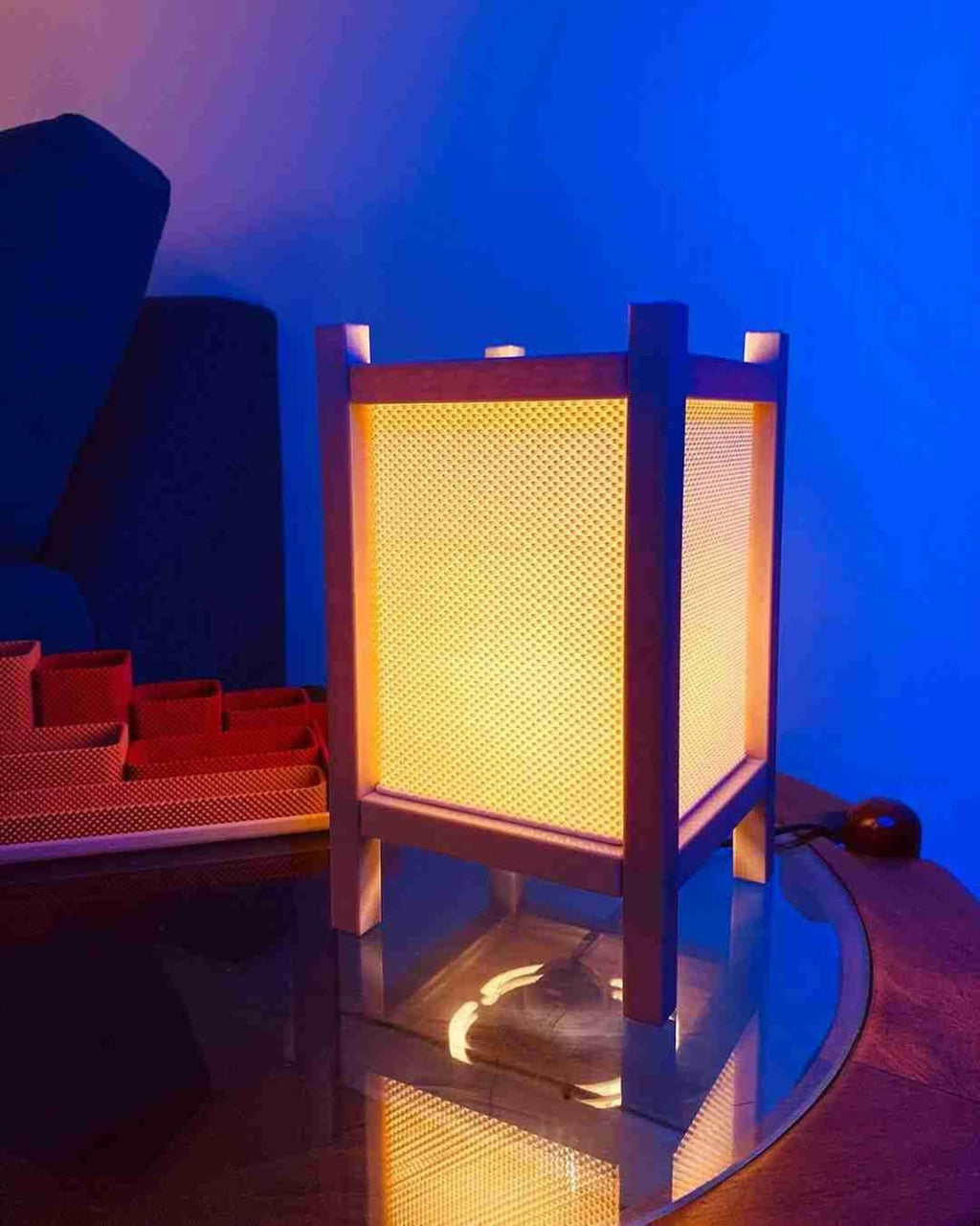 Riku 3D printed modern table lamp glowing on a bedside table