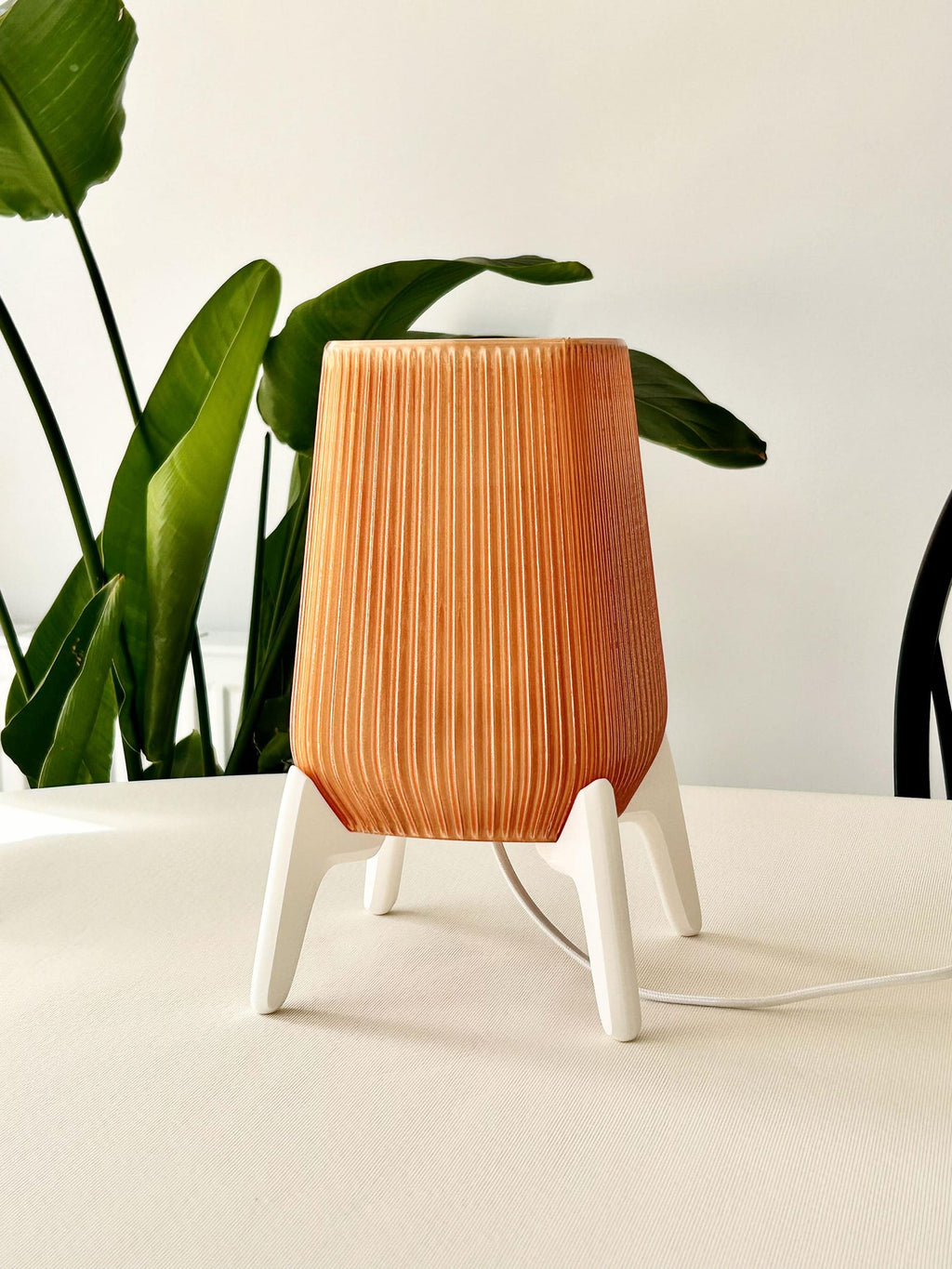 Sculptural tripod base of the modern table lamp