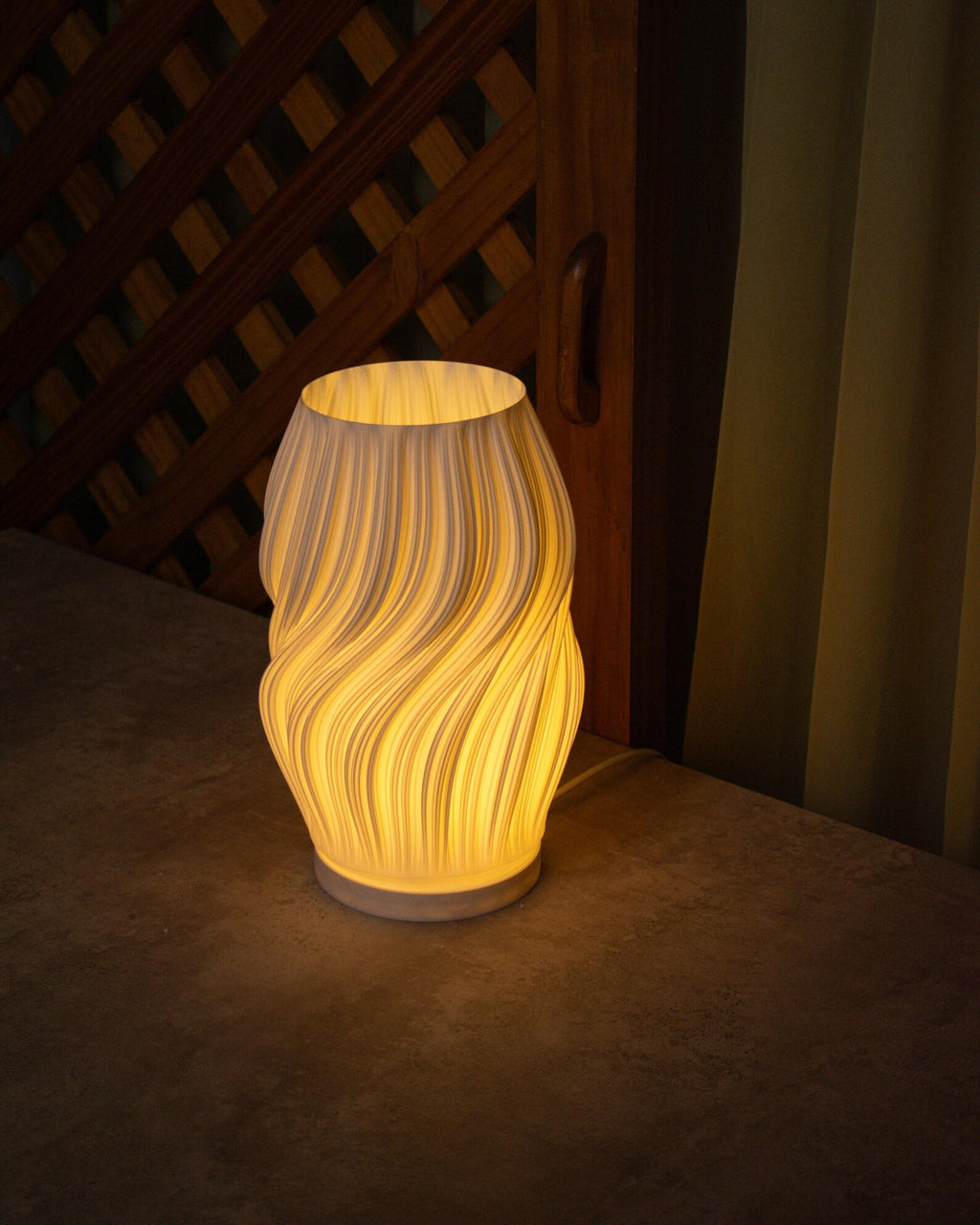 Silk table lamp lit with warm ambient glow