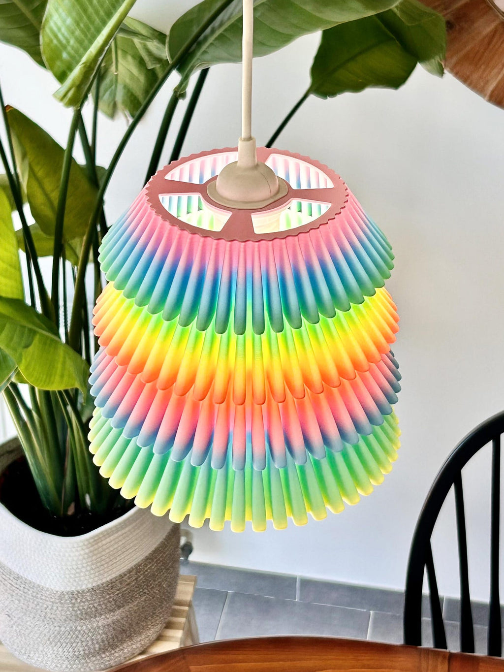 Falda pendant light glowing over a table