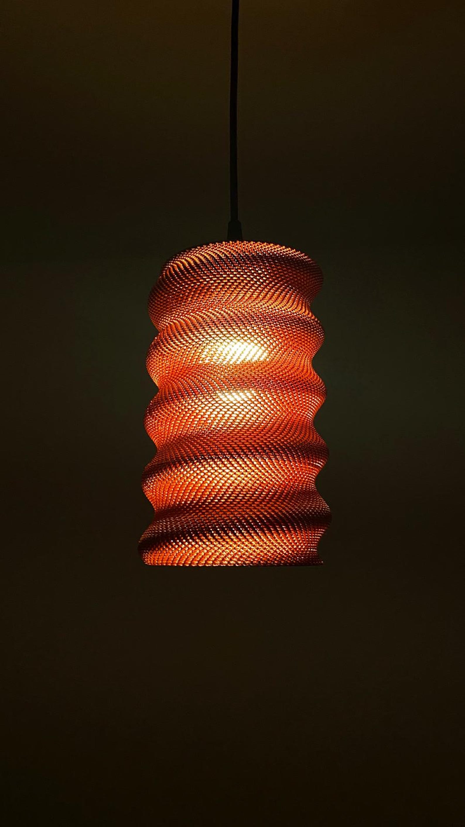 Spiral shade glowing as a pendant light