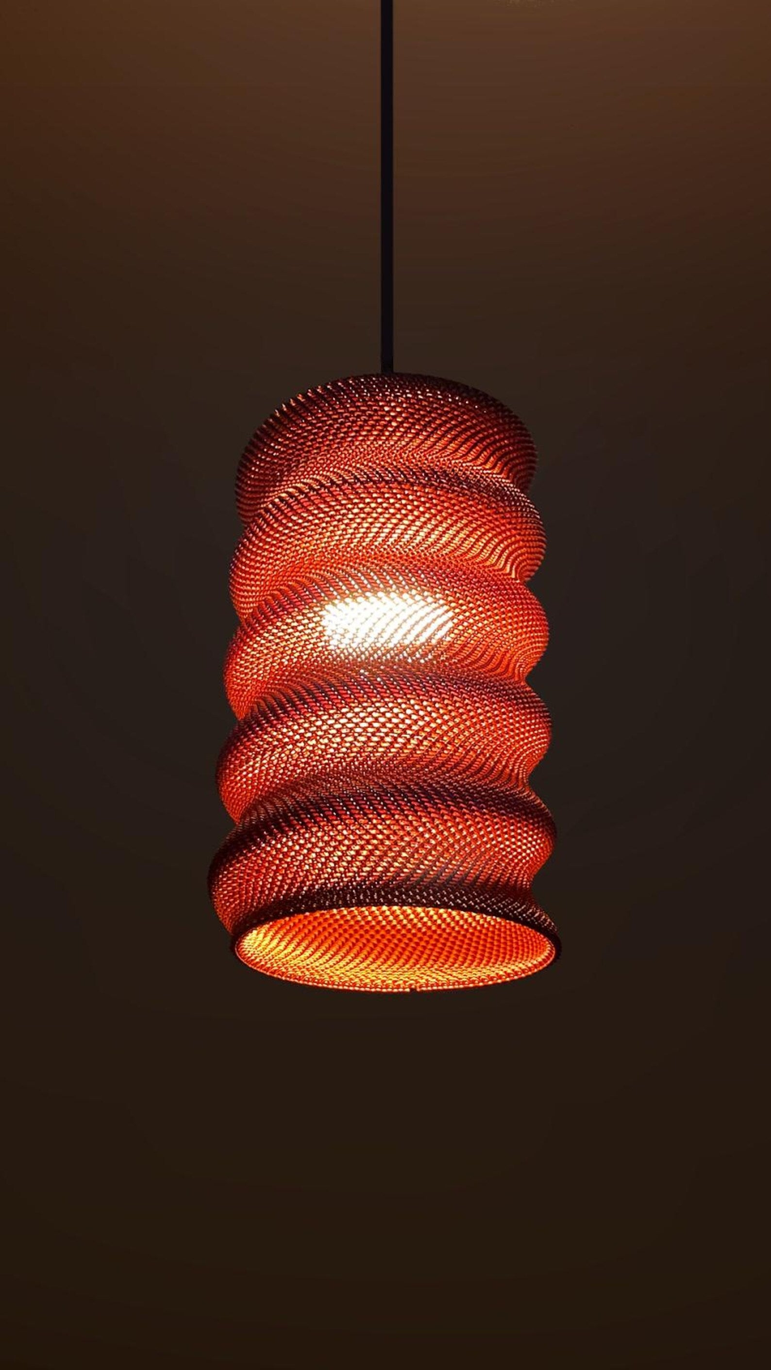 Detail of the warm woven glow of the spiral shade
