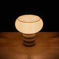 Michelle 3D printed ripple texture table lamp glowing on a console