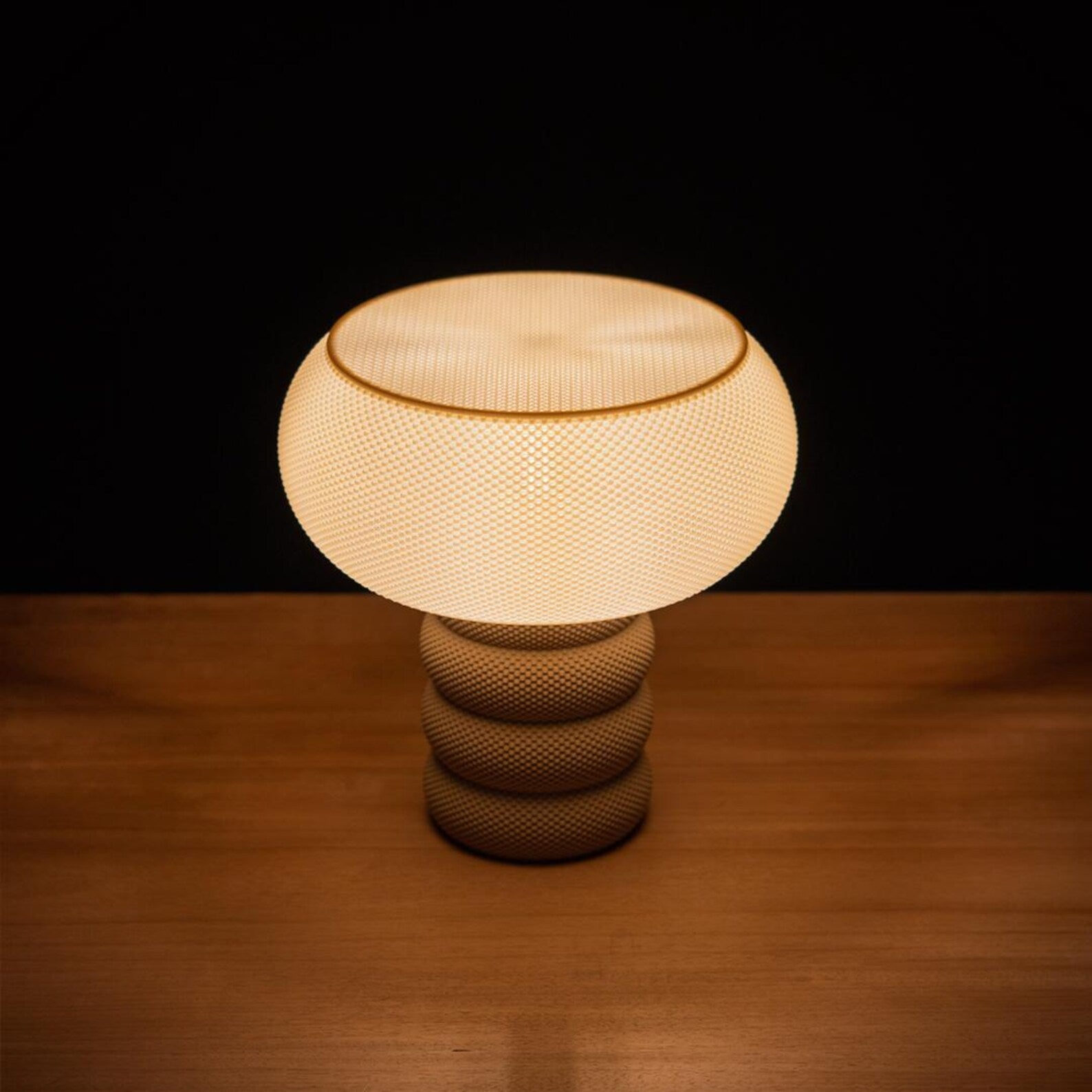 Michelle 3D printed ripple texture table lamp glowing on a console