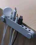 Orbit 8 slot 3D printed cable organizer holding charging cables on a desk