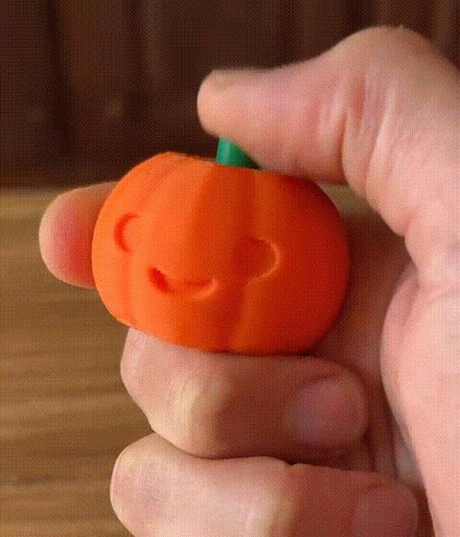 Pumpkin fidget clicker — in hand