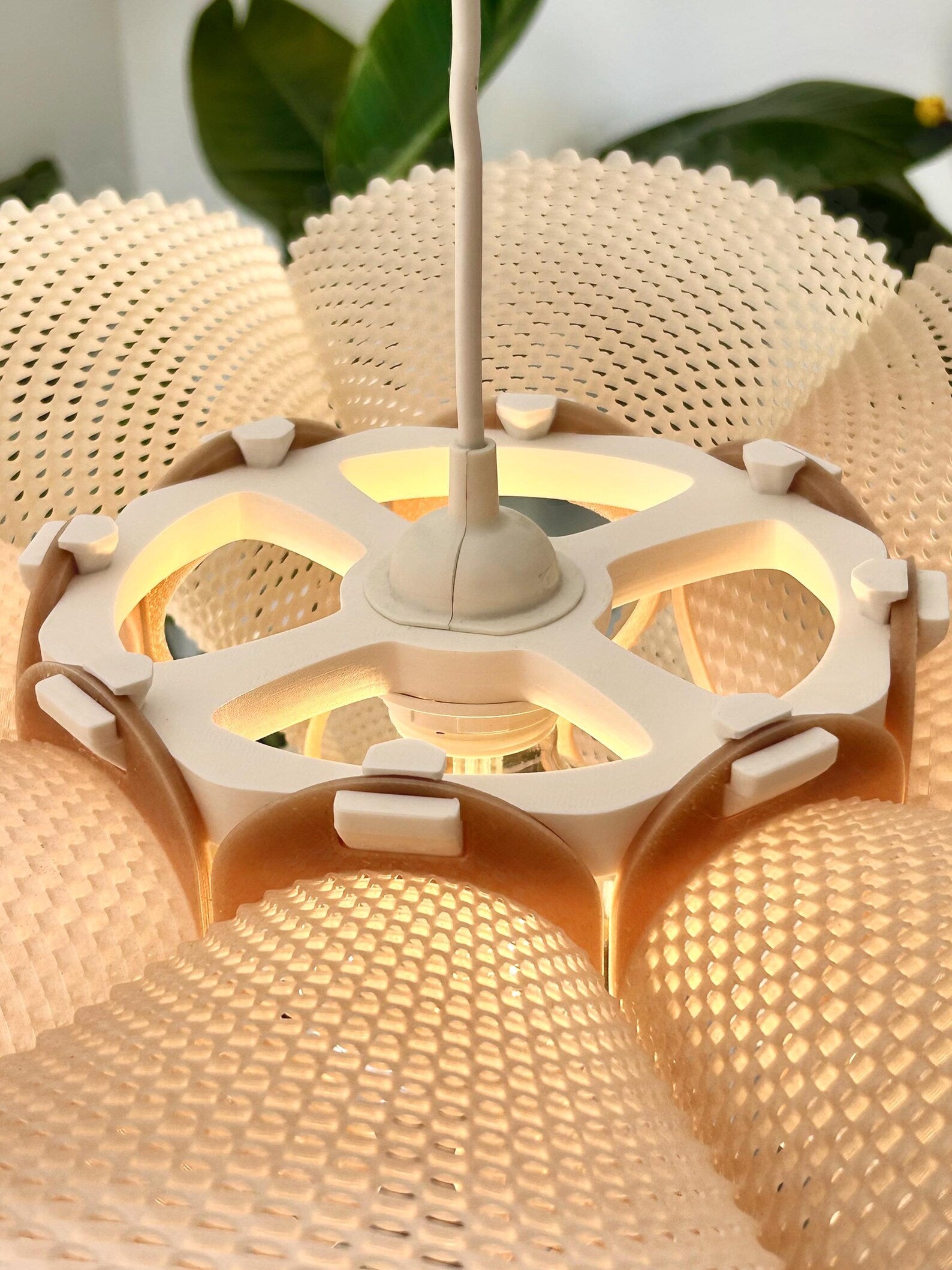 Pleated pendant light casting soft woven shadows
