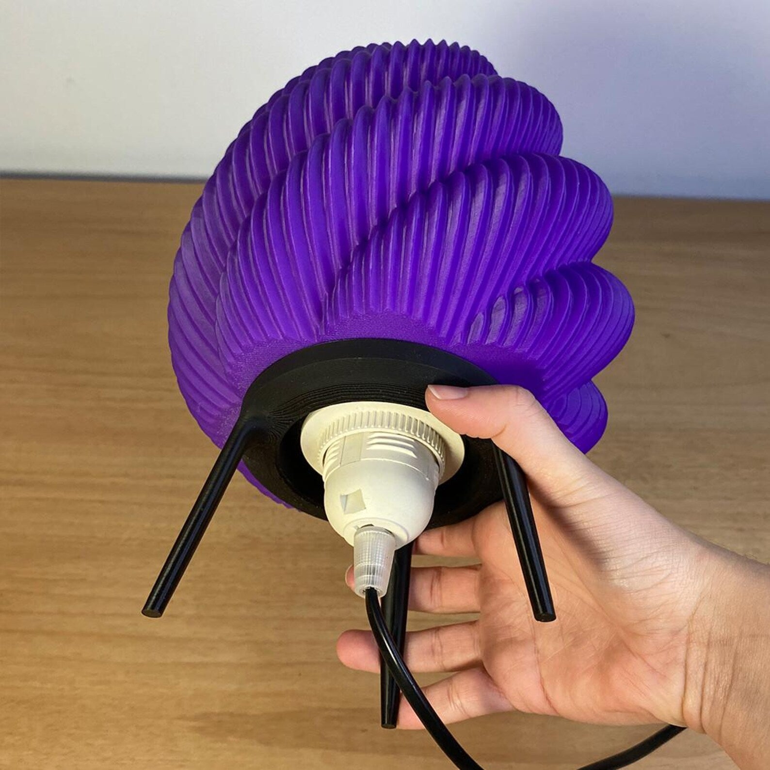 Kamba tripod lamp styled on a nightstand