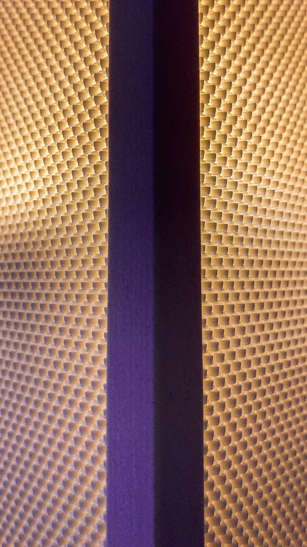 Shoji wall sconce glowing on a wall