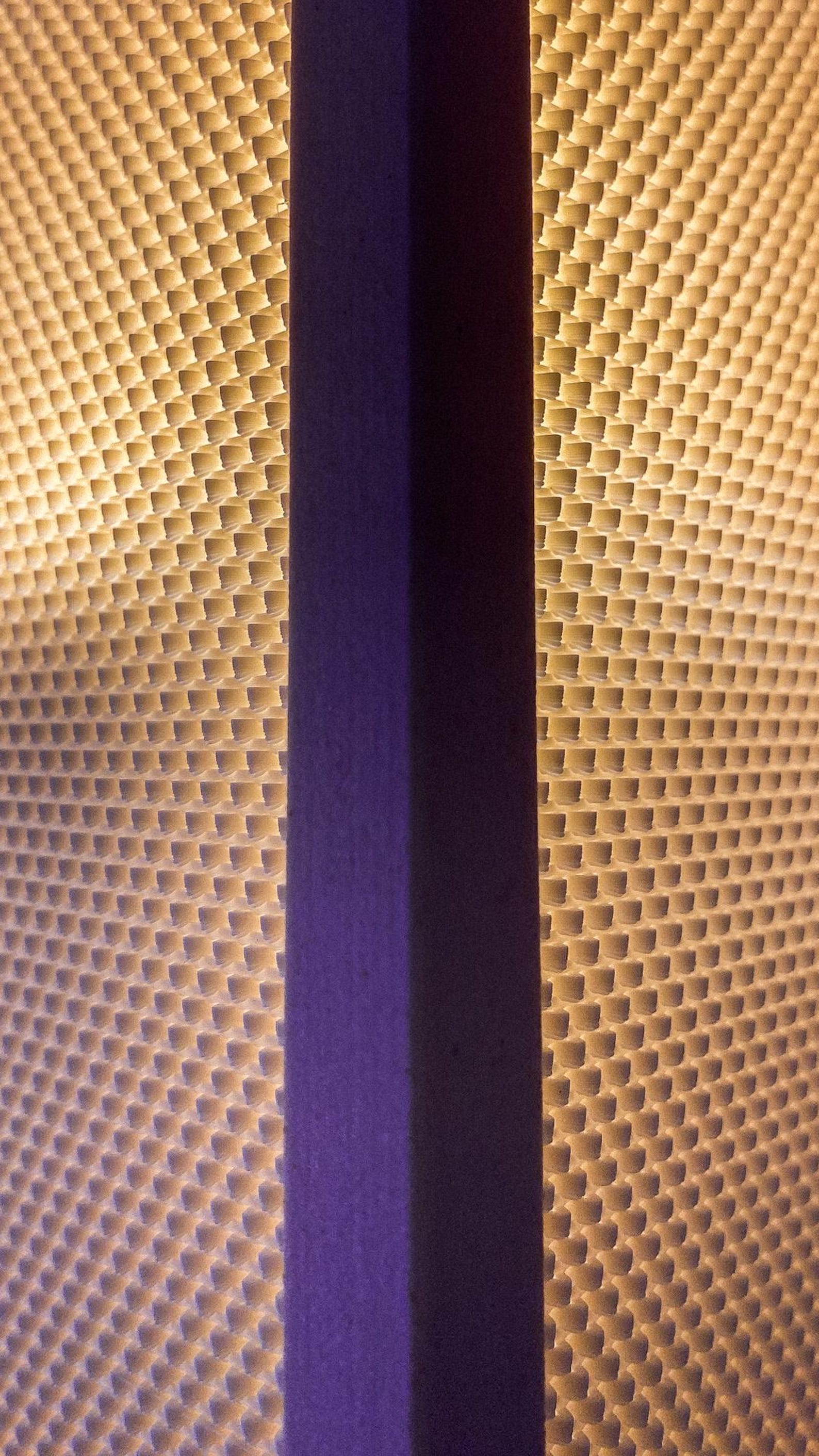 Shoji wall sconce glowing on a wall